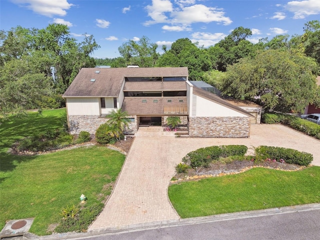 2103 N Golfview Dr, Plant City, FL 33566 - mid-century inspired home with stone siding, a front lawn, and stairway