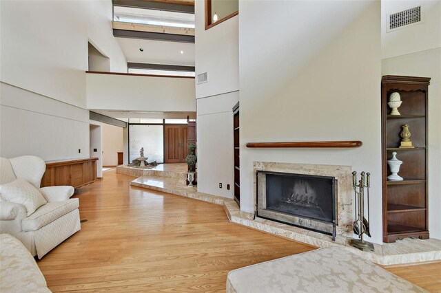 2103 N Golfview Dr, Plant City, FL 33566 - living room with a high ceiling, a high end fireplace, and wood finished floors