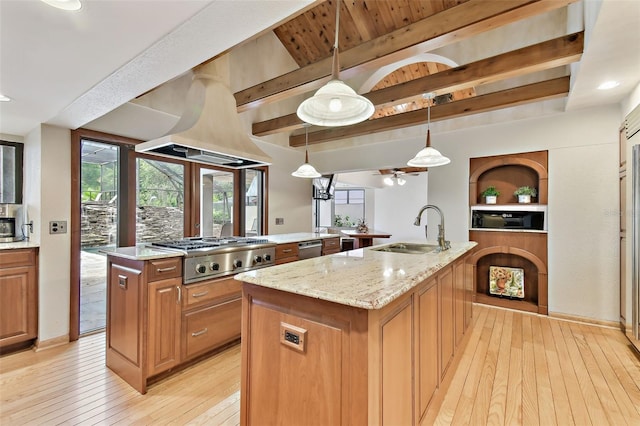 2103 N Golfview Dr, Plant City, FL 33566 - kitchen featuring a center island with sink, stainless steel appliances, beam ceiling, light wood-type flooring, and light stone counters