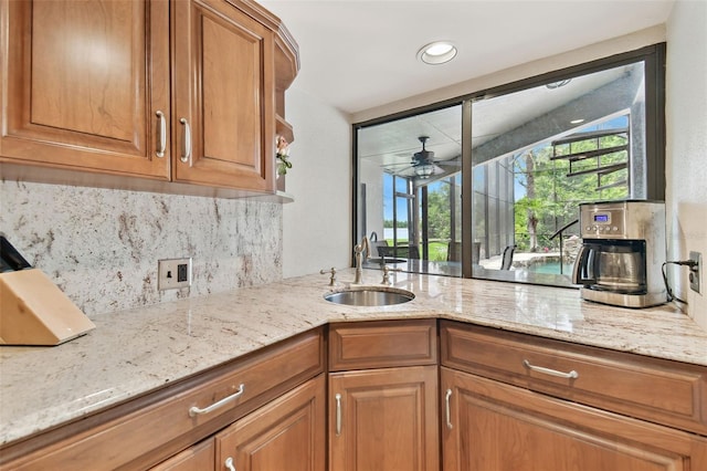 2103 N Golfview Dr, Plant City, FL 33566 - kitchen featuring light stone countertops, tasteful backsplash, brown cabinets, and a ceiling fan