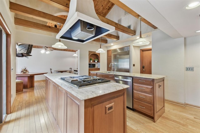 2103 N Golfview Dr, Plant City, FL 33566 - kitchen featuring a center island with sink, appliances with stainless steel finishes, light wood-style floors, and brown cabinetry