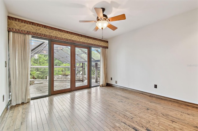 2103 N Golfview Dr, Plant City, FL 33566 - spare room with french doors, healthy amount of natural light, ceiling fan, and wood-type flooring