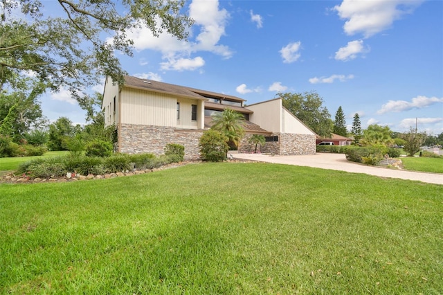2103 N Golfview Dr, Plant City, FL 33566 - view of front facade featuring stone siding, a front yard, and driveway