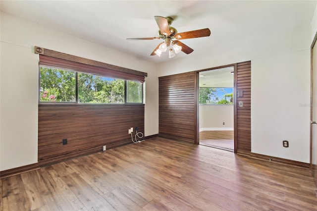 2103 N Golfview Dr, Plant City, FL 33566 - unfurnished bedroom with multiple windows, wood finished floors, and ceiling fan