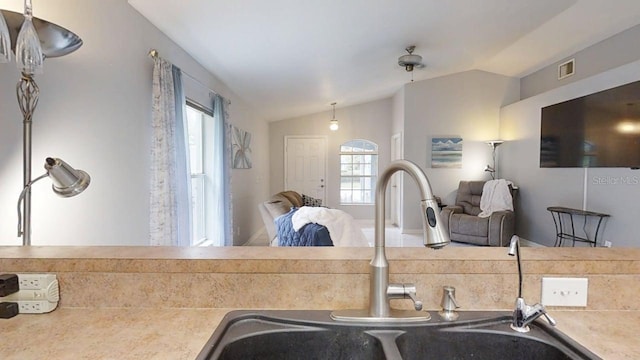 7010 Kendall Heath Way, Land O Lakes, FL 34637 - kitchen featuring vaulted ceiling, plenty of natural light, open floor plan, and light countertops