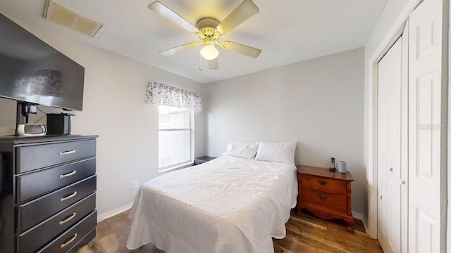 7010 Kendall Heath Way, Land O Lakes, FL 34637 - bedroom with a closet, wood finished floors, and ceiling fan