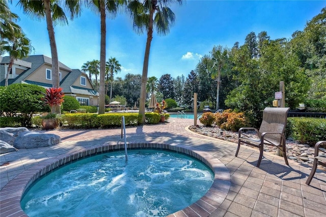 7010 Kendall Heath Way, Land O Lakes, FL 34637 - community pool featuring a hot tub and a patio