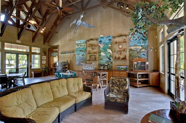 7010 Kendall Heath Way, Land O Lakes, FL 34637 - living area featuring high vaulted ceiling, french doors, wood finished floors, a ceiling fan, and wooden walls