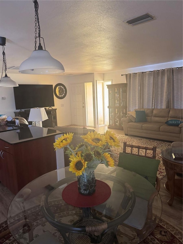 10185 Santiago Ct, Seminole, FL 33776 - dining room with a textured ceiling and wood finished floors