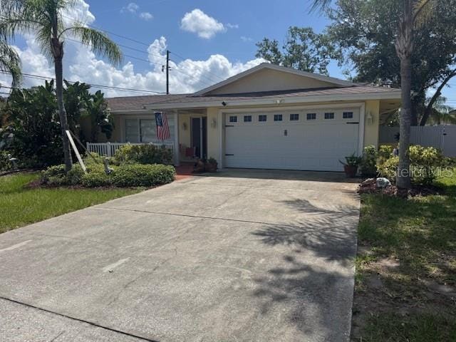 10185 Santiago Ct, Seminole, FL 33776 - single story home with a garage, driveway, and stucco siding