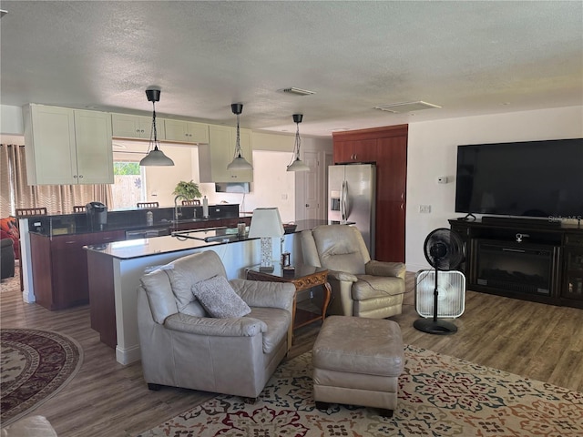 10185 Santiago Ct, Seminole, FL 33776 - living area featuring dark wood-type flooring and a textured ceiling