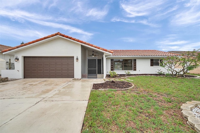 734 Flamingo Dr, Apollo Beach, FL 33572 - single story home featuring a tiled roof, brick siding, a garage, a front lawn, and ceiling fan
