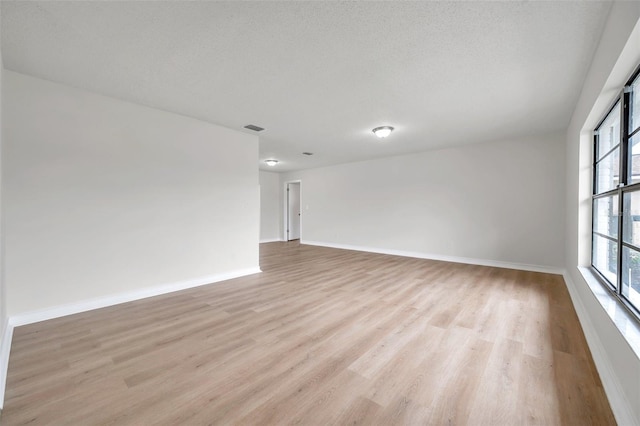 734 Flamingo Dr, Apollo Beach, FL 33572 - empty room featuring light wood finished floors and baseboards