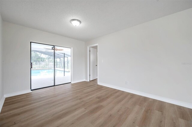 734 Flamingo Dr, Apollo Beach, FL 33572 - empty room featuring wood finished floors and a textured ceiling