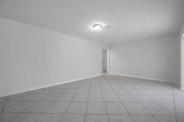734 Flamingo Dr, Apollo Beach, FL 33572 - spare room with a textured ceiling and light tile patterned floors