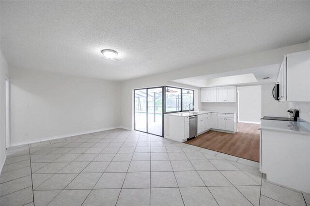 734 Flamingo Dr, Apollo Beach, FL 33572 - unfurnished living room with a textured ceiling and light tile patterned floors