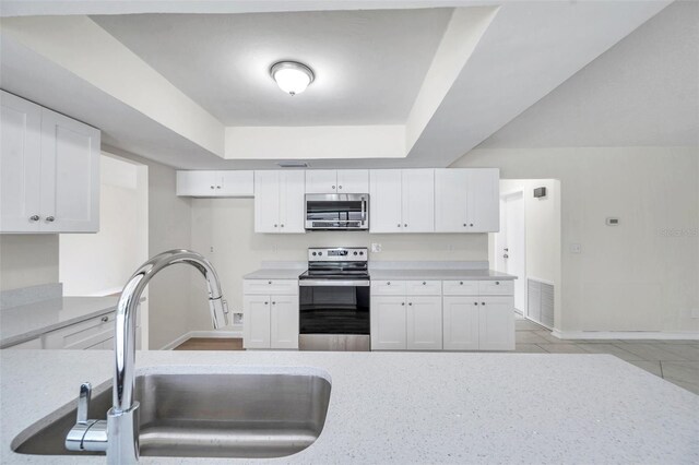734 Flamingo Dr, Apollo Beach, FL 33572 - kitchen featuring appliances with stainless steel finishes, white cabinets, and light countertops