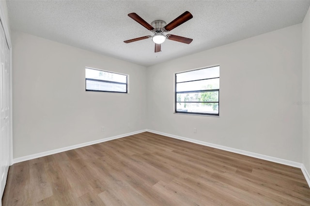 734 Flamingo Dr, Apollo Beach, FL 33572 - unfurnished room featuring light wood-type flooring, ceiling fan, and a textured ceiling
