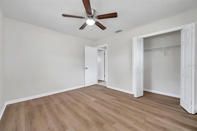734 Flamingo Dr, Apollo Beach, FL 33572 - unfurnished bedroom featuring light wood-style flooring, a closet, and a ceiling fan