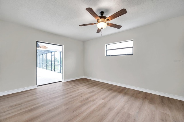 734 Flamingo Dr, Apollo Beach, FL 33572 - unfurnished room featuring plenty of natural light, light wood-type flooring, a textured ceiling, and a ceiling fan