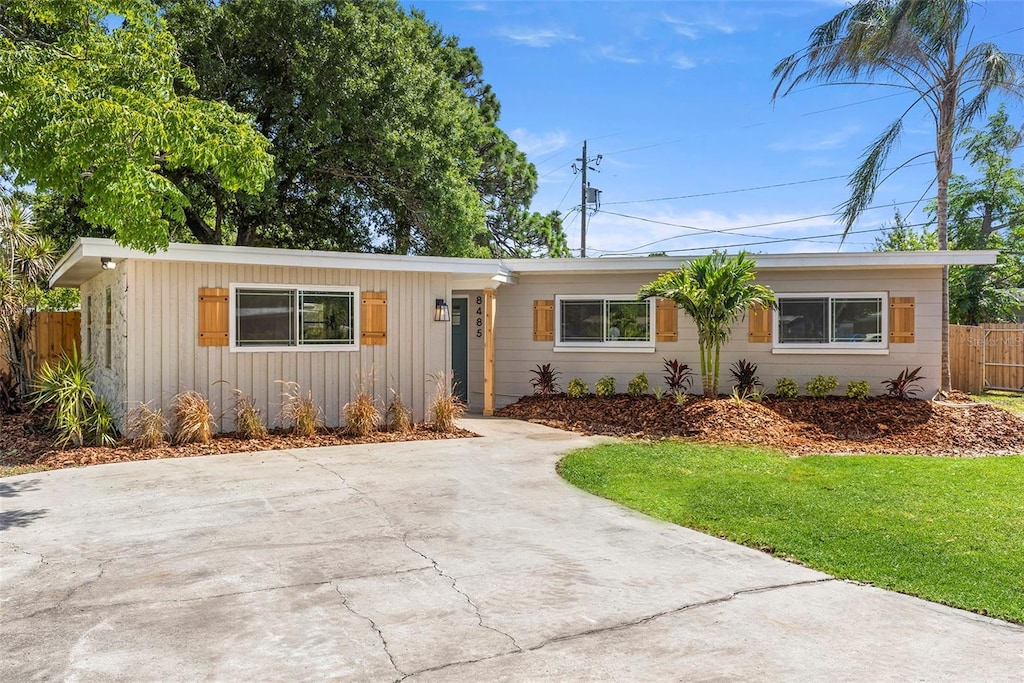 8485 Pelican Ln, Seminole, FL 33777 - single story home featuring driveway and board and batten siding