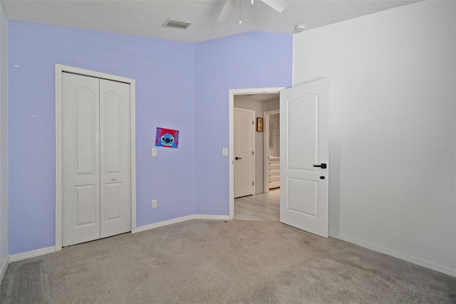 8526 Quarter Horse Dr, Riverview, FL 33578 - unfurnished bedroom with light colored carpet, a closet, and a ceiling fan