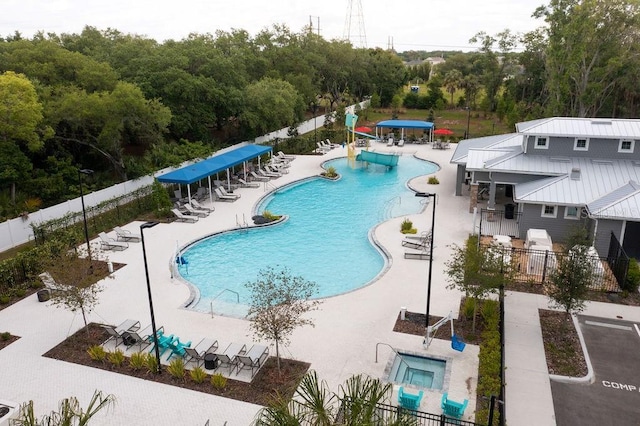 8526 Quarter Horse Dr, Riverview, FL 33578 - community pool featuring a patio, a water slide, and view of wooded area