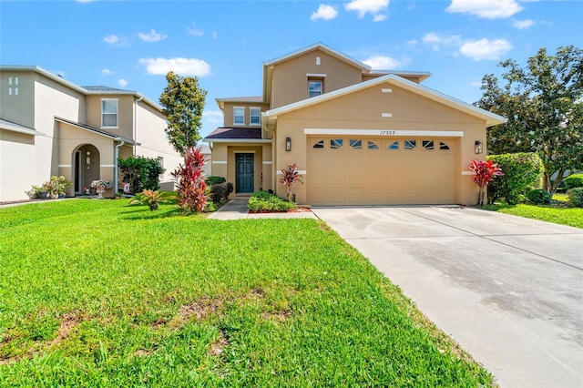 17509 Queensland St, Land O Lakes, FL 34638 - traditional home featuring stucco siding, concrete driveway, a front yard, and a garage