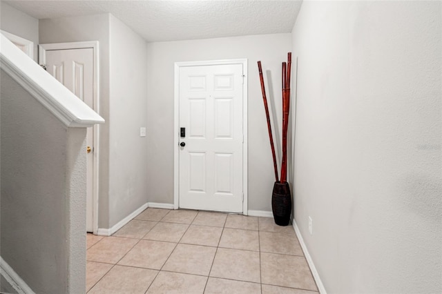17509 Queensland St, Land O Lakes, FL 34638 - entrance foyer featuring light tile patterned floors and a textured ceiling