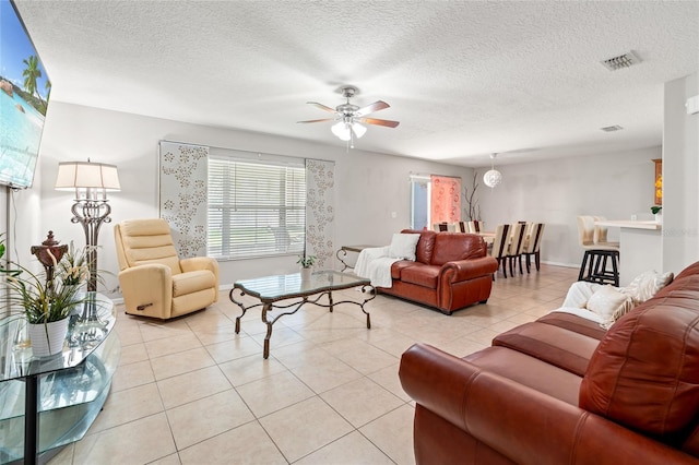 17509 Queensland St, Land O Lakes, FL 34638 - living room with ceiling fan, light tile patterned flooring, and a textured ceiling