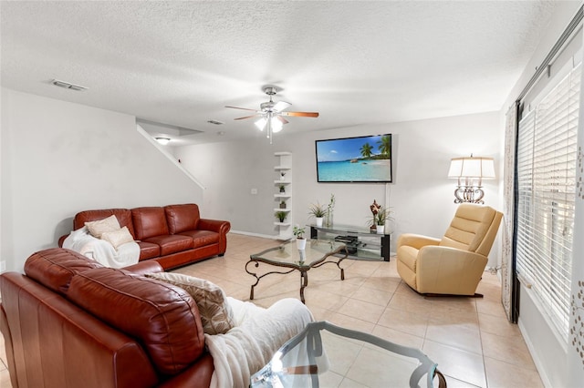 17509 Queensland St, Land O Lakes, FL 34638 - living area with ceiling fan, light tile patterned floors, and a textured ceiling