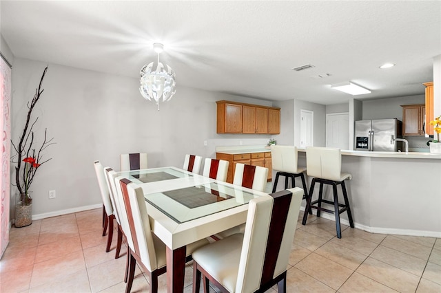17509 Queensland St, Land O Lakes, FL 34638 - dining space with light tile patterned floors, a chandelier, and recessed lighting