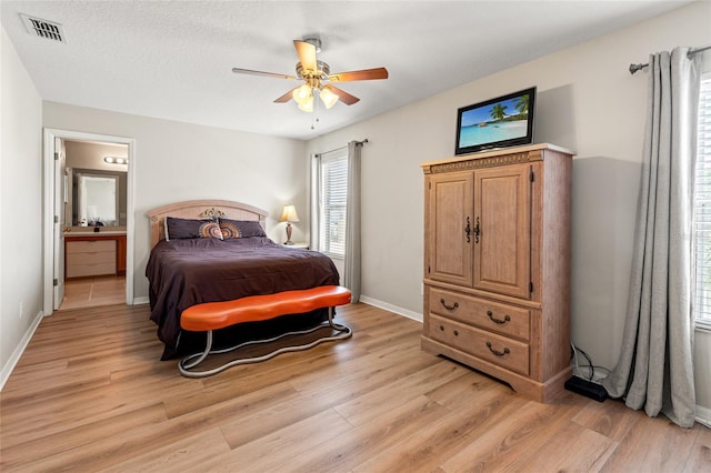 17509 Queensland St, Land O Lakes, FL 34638 - bedroom featuring light wood-style floors, ensuite bath, and ceiling fan