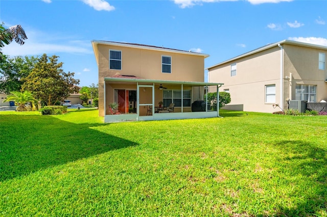 17509 Queensland St, Land O Lakes, FL 34638 - rear view of property with a sunroom, a lawn, ceiling fan, and stucco siding