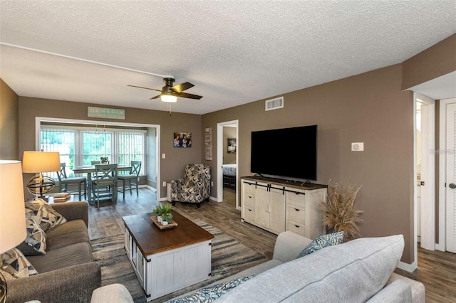 940 Virginia St Unit 303, Dunedin, FL 34698 - living room with a ceiling fan, a textured ceiling, and wood finished floors