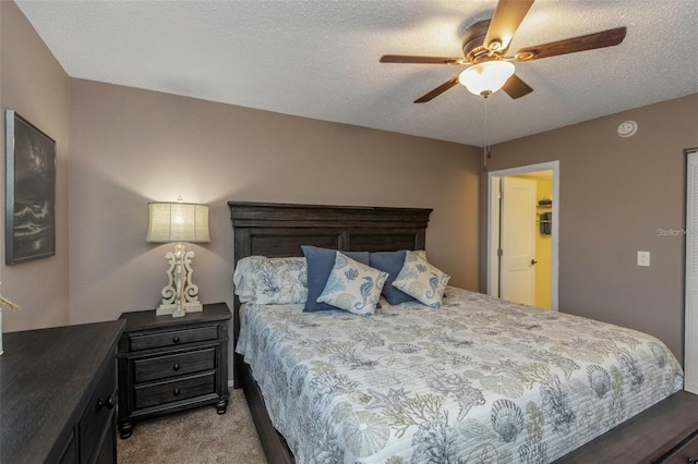 940 Virginia St Unit 303, Dunedin, FL 34698 - bedroom featuring light carpet, a ceiling fan, and a textured ceiling