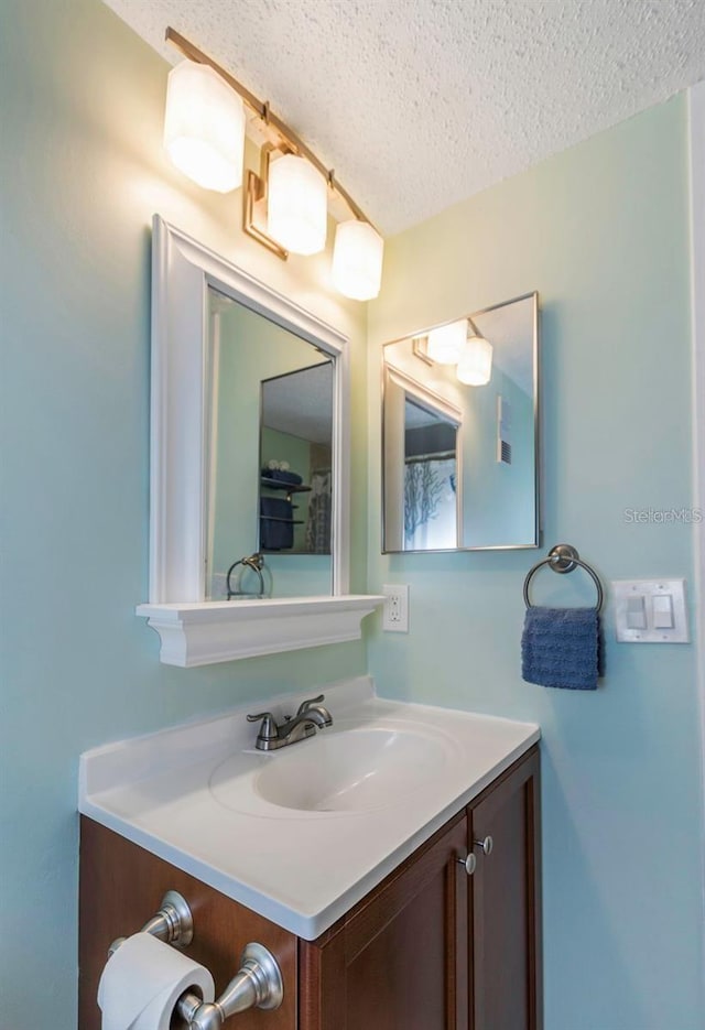940 Virginia St Unit 303, Dunedin, FL 34698 - bathroom with a textured ceiling and vanity