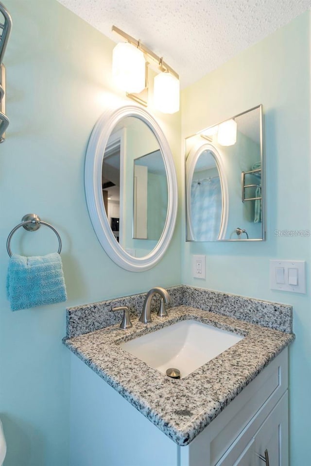 940 Virginia St Unit 303, Dunedin, FL 34698 - bathroom with a textured ceiling and vanity