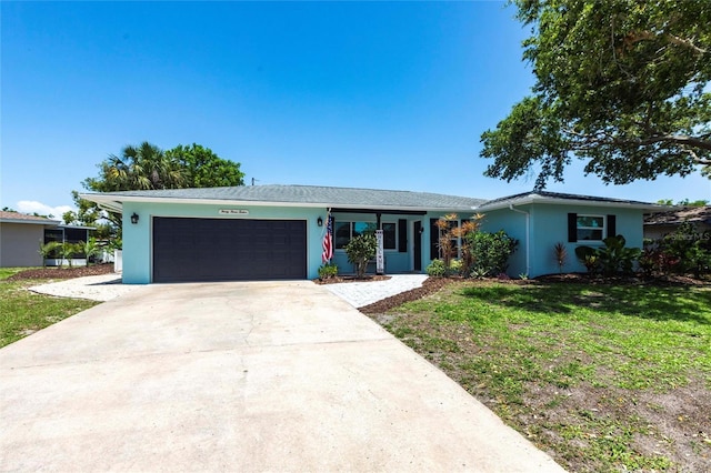 3312 Kenmore Dr, Sarasota, FL 34231 - ranch-style home featuring stucco siding, a garage, concrete driveway, and a front lawn