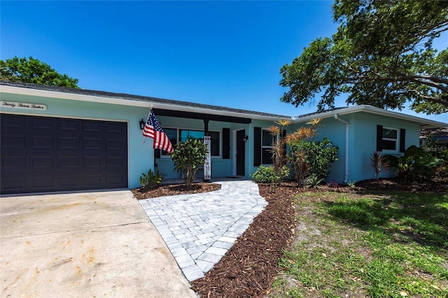 3312 Kenmore Dr, Sarasota, FL 34231 - single story home with stucco siding, an attached garage, and concrete driveway