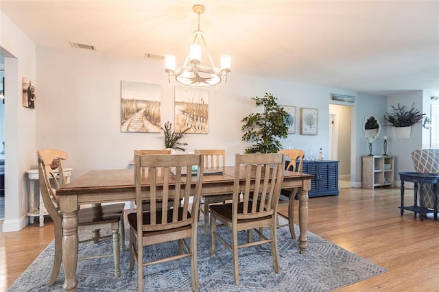 3312 Kenmore Dr, Sarasota, FL 34231 - dining area featuring a chandelier and wood finished floors