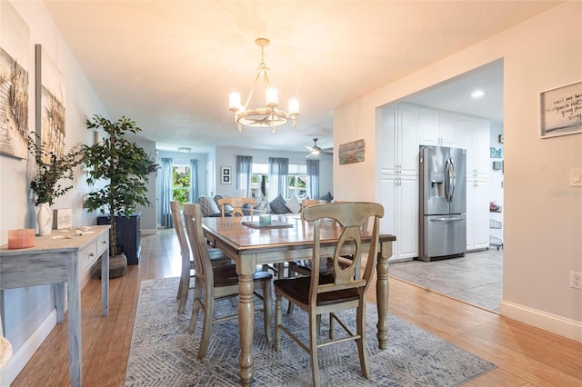 3312 Kenmore Dr, Sarasota, FL 34231 - dining space featuring a chandelier, light wood-type flooring, and a ceiling fan