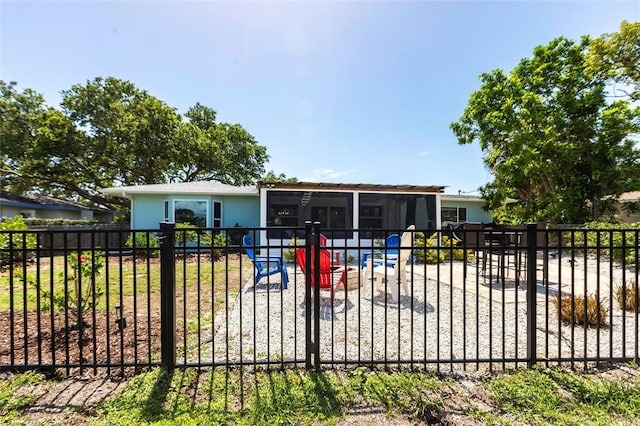 3312 Kenmore Dr, Sarasota, FL 34231 - view of front of house with a sunroom, a fenced backyard, and a gate