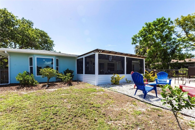 3312 Kenmore Dr, Sarasota, FL 34231 - back of property featuring a sunroom, a patio, and stucco siding