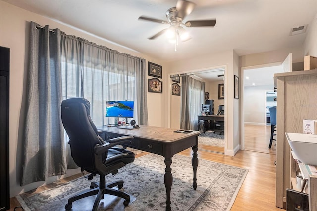 3312 Kenmore Dr, Sarasota, FL 34231 - office area featuring a ceiling fan, light wood-style floors, and healthy amount of natural light