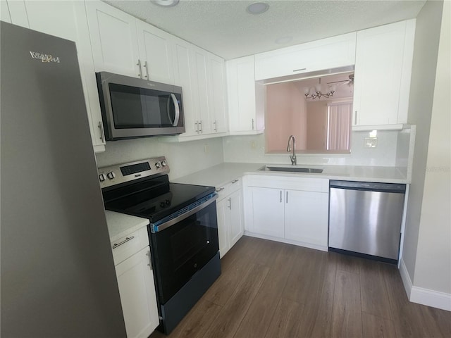 209 Corkwood Ln, Oldsmar, FL 34677 - kitchen featuring stainless steel appliances, dark wood-style floors, light countertops, and white cabinetry