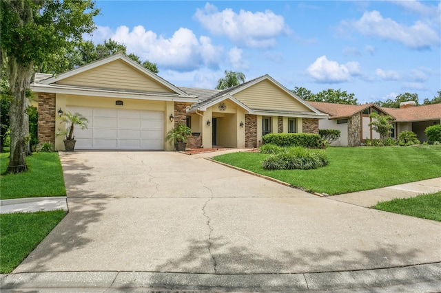 3262 Westcott Ct, Palm Harbor, FL 34684 - view of front of property featuring a front lawn, a garage, concrete driveway, stucco siding, and stone siding