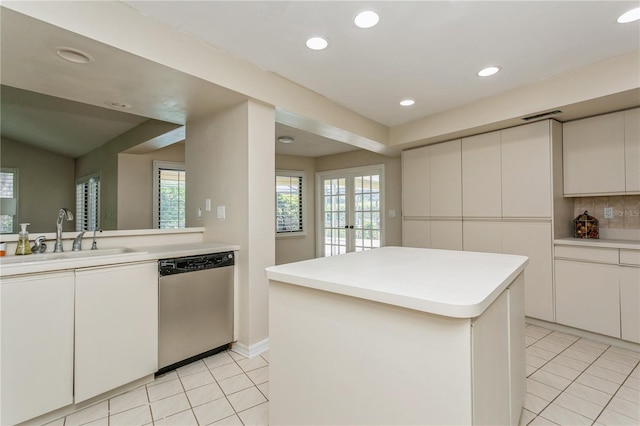 3262 Westcott Ct, Palm Harbor, FL 34684 - kitchen featuring stainless steel dishwasher, light tile patterned floors, a center island, light countertops, and recessed lighting