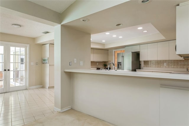 3262 Westcott Ct, Palm Harbor, FL 34684 - kitchen featuring stainless steel fridge, light countertops, backsplash, recessed lighting, and a peninsula