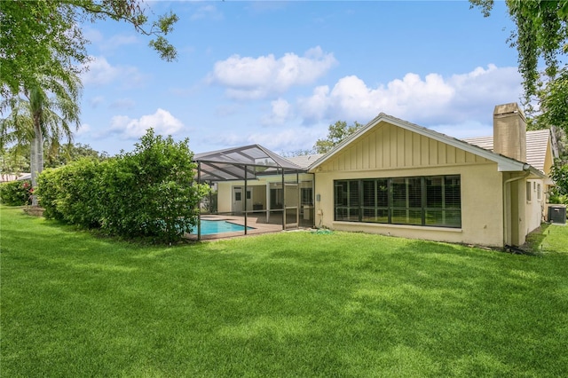 3262 Westcott Ct, Palm Harbor, FL 34684 - back of property with a chimney, a lawn, an outdoor pool, a patio area, and stucco siding
